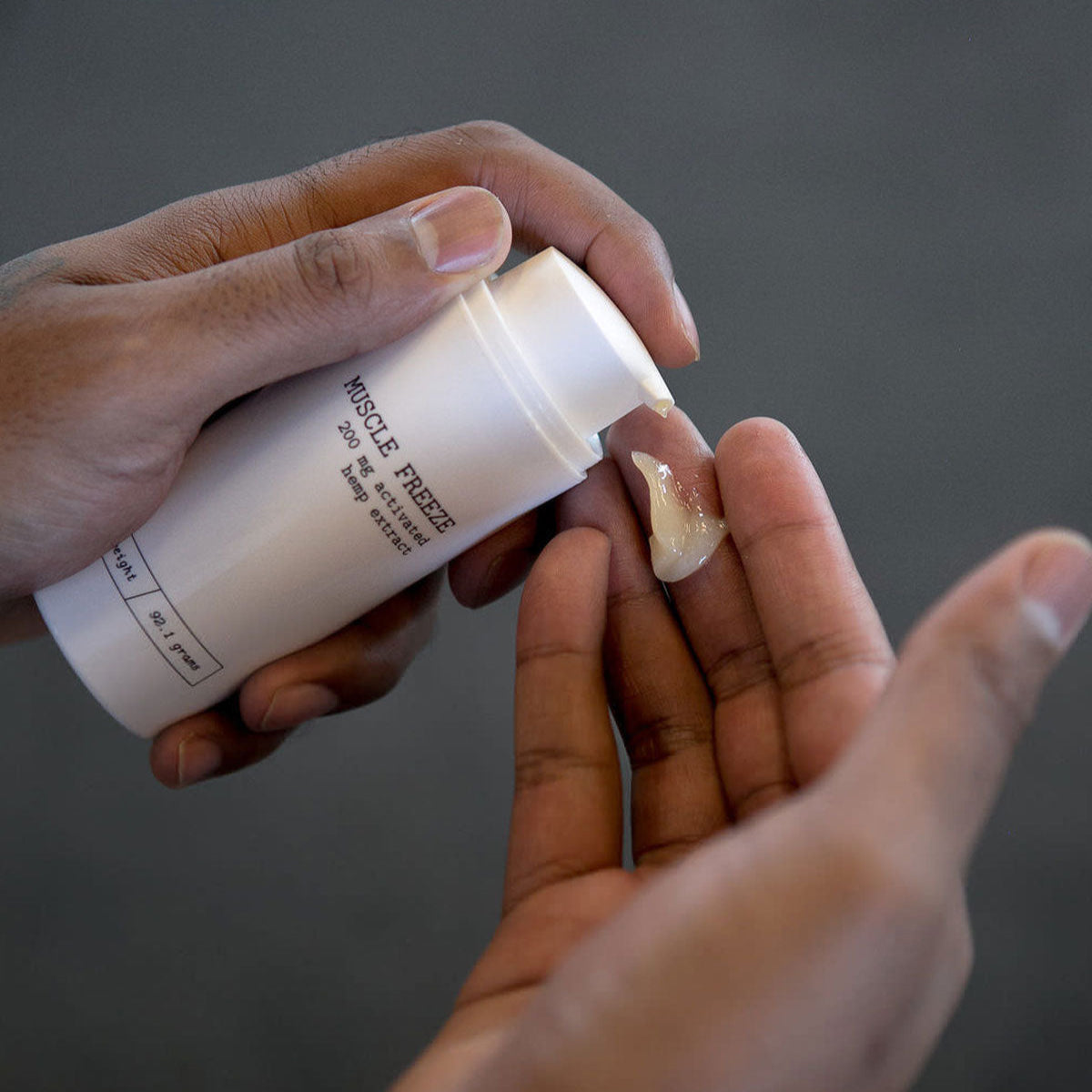 person dispensing Muscle Freeze