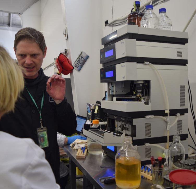 man and woman talking in science lab